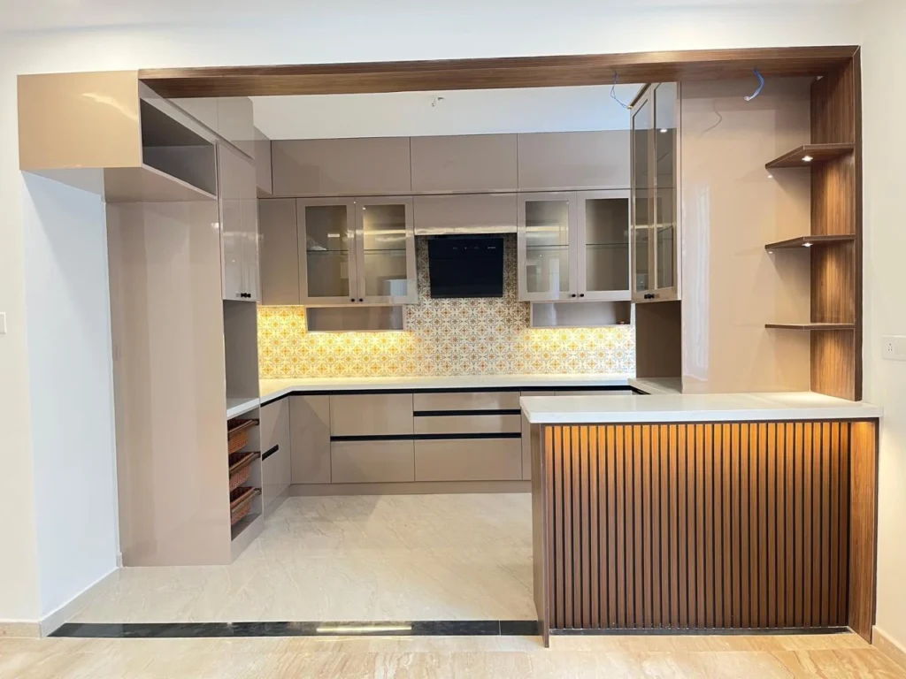 Completed 3 BHK modular kitchen with patterned backsplash and fluted wood breakfast counter