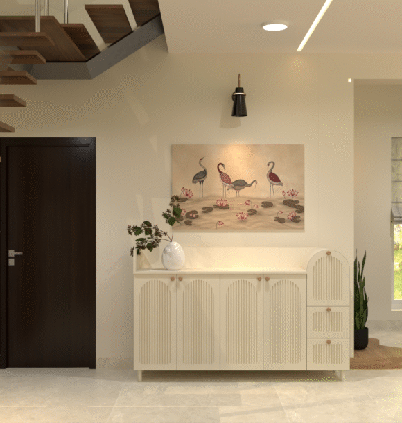 Living room console wall with cream fluted cabinet shutters, bird and lotus wall art, indoor plants, staircase, wooden accents, warm lighting, and neutral interiors.
