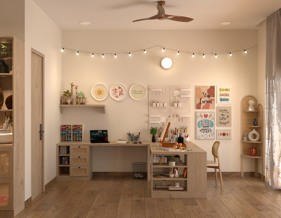 Warm interior workspace with wooden desks, craft storage, wall decor, string lights, open shelving, and large glass doors with sheer curtains.