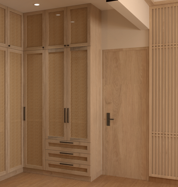 Built-in wooden wardrobe wall with cane cabinet doors, black handles, matching wood door, vertical slat partition, and warm neutral interior finishes.