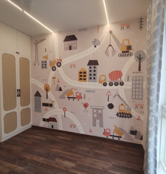 Kids bedroom with construction-themed wall mural, white wardrobe with textured panels, dark wooden flooring, large window, curtains, and linear ceiling lights.
