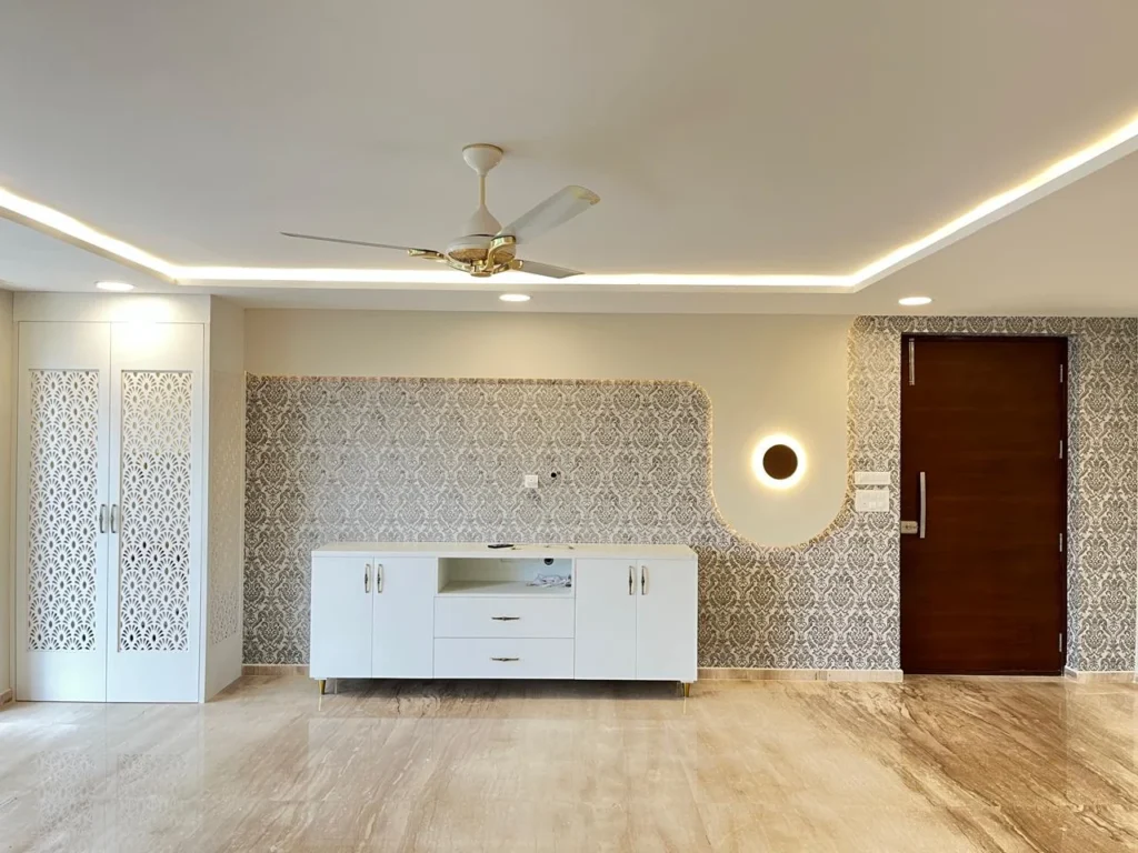 3 BHK TV console with integrated puja unit and patterned feature wall